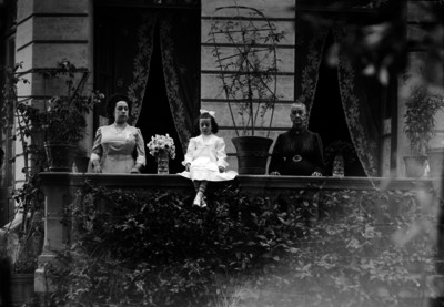 Anciana, mujer y niña en un balcón, retrato