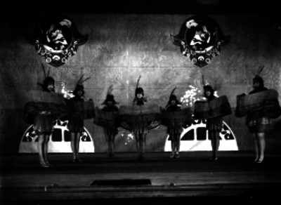 Bailarines con atuendo de fantasía durante una escena teatral