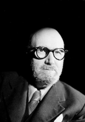 Leon Felipe, escritor, viste de traje y corbata, usa anteojos, retrato