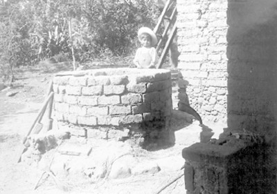 Niño indígena junto a un horno, retrato