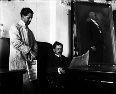 José Gómez Ugarte leyendo un periódico en una oficina de El Imparcial
