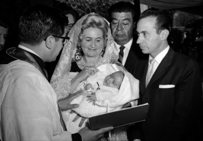 Jorge O'farril, empresario con su hijo y sus padrinos en su bautizo reciben indiczaciones del sacerdote
