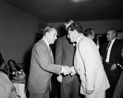 Hombres se saludan durante reunión social