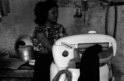 Mujer lavando ropa en una lavadora