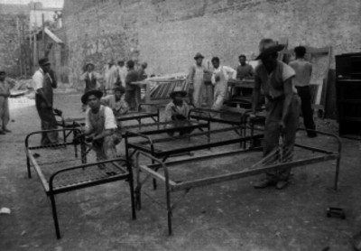 Presos trabajando en la reparación de camas