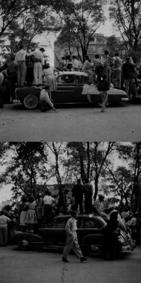 Hombres, mujeres y niños sobre un auto presenciando un desfile