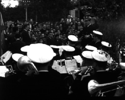 Banda musical de la marina dando un concierto al aire libre en un parque