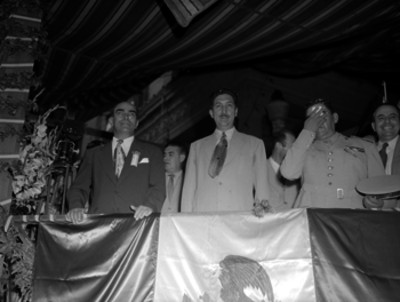 Miguel Alemán Valdés y funcionarios presidiendo una ceremonia en un balcón durante su gira presidencial al Norte del País, retrato de grupo