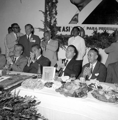 Adolfo López Mateos, M. Quirosco y políticos aplaudiendo en un banquete