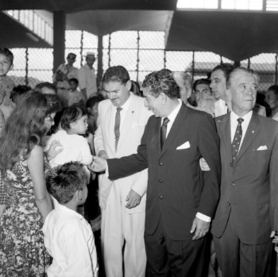 Adolfo López Mateos abrazando a una mujer durante una ceremonia pública