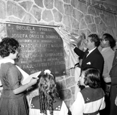 Adolfo López Mateos abrazando a una niña durante la inauguración de la escuela Josefa Ortiz de Domínguez