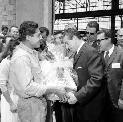Adolfo López Mateos recibiendo regalo de manos de un trabajador, durante su visita a Cd. Sahagún