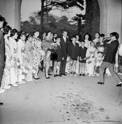 Adolfo López Mateos y Eva Sámano de López Mateos durante recepción en Tokio, entre niños de grupo coral