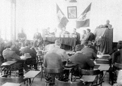 Hombres durante una ceremonia en el interior de una aula