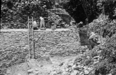 Hombres trabajan en reconstrucción de edificio prehispánico, Palenque