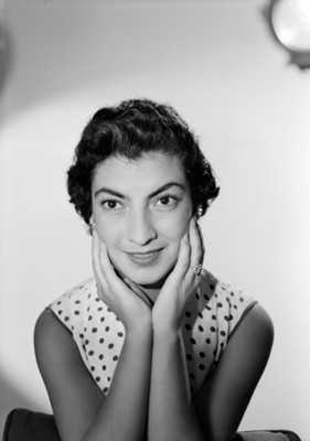 Bertha Fernández, actriz, con las manos en sus mejillas, sonríe, retrato
