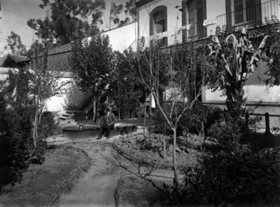 Hombre sentado en fuente de una casa
