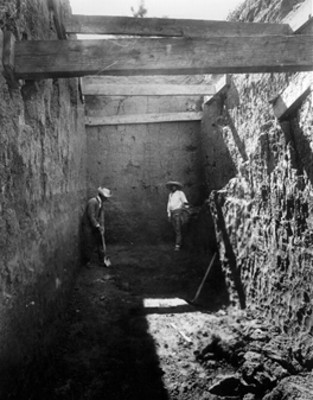 Hombres en excavación dentro de una estructura arqueológica