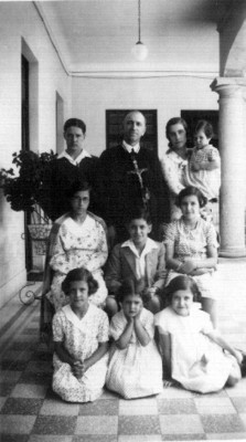 Familia reunida en el portico de una casa, retrato de grupo