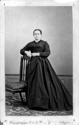 Mujer de pie junto a silla