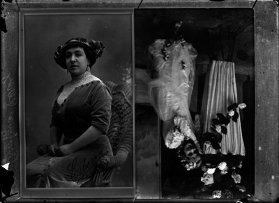 "Amparo Pérez", sentada, y niña junto a un adorno floral, reprografía