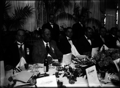 Rafael Martínez de Escobar, diputado, sentado a la mesa con varias personas, durante un banquete