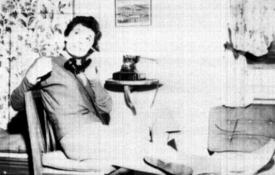Modelo hablando por teléfono, posando en el interior de una casa, retrato