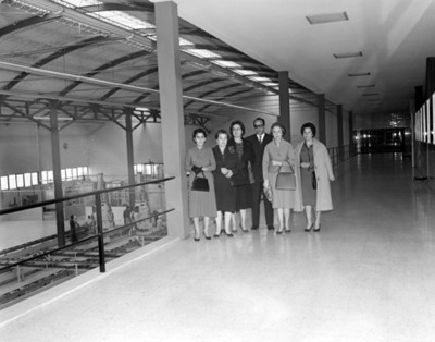 Personas en pasillo durante visita a empacadora, retrato de grupo