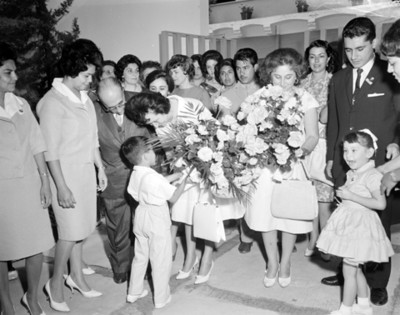 Eva Samáno de López Mateos recibe flores de un niño en el Instituto de Protección a la Infancia