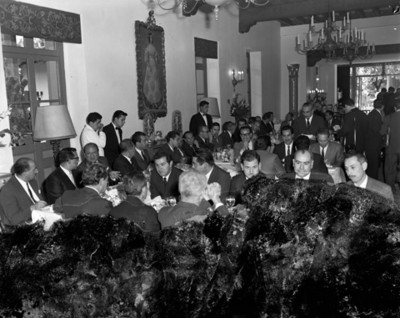 Empresarios conversan durante banquete en un salón