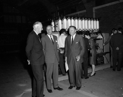 Hombre conversa junto a una máquina industrial