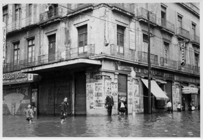 Gente cruza la esquina Isabel la Católica y 16 de septiembre inundada