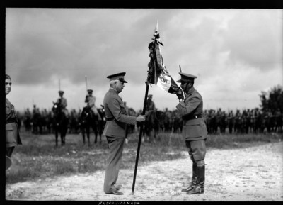 Pedro J. Almada y un militar rindiendo honores a la Bandera
