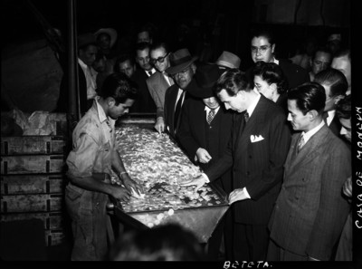 Ramón Beteta observando la acuñación de monedas en la Casa de Moneda